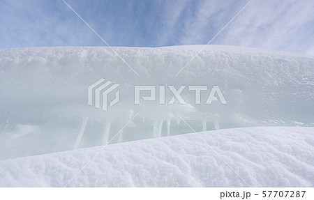 White clean snowdrifts and icicles close-up. Pile 57707287