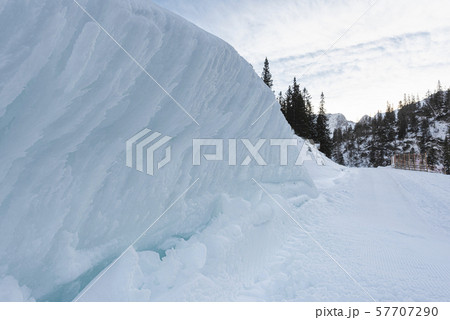 Snow wall on the roadside in an alpine scenery Snow wall on the roadside in an alpine scenery 57707290