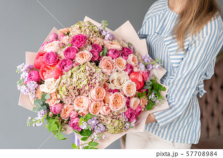 Large Beautiful bouquet of mixed flowers in woman hand. Floral shop concept . Beautiful fresh cut 57708984