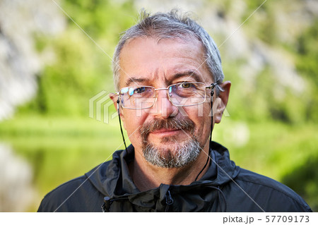Smiling mature man wearing glasses. 57709173