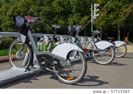 Bicycles for rent are on a bicycle parking lot on a city street 57715587