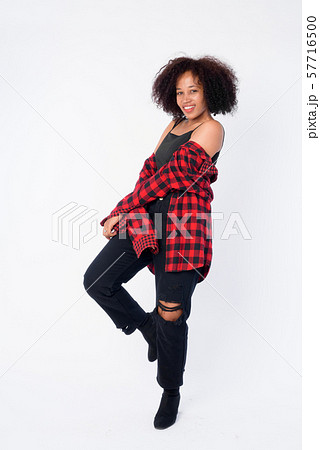 Full body shot of happy young beautiful African hipster woman smiling 57716500