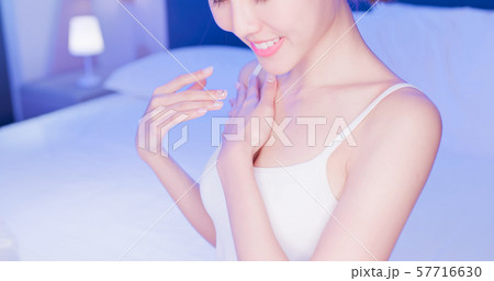 woman apply cream with chest 57716630