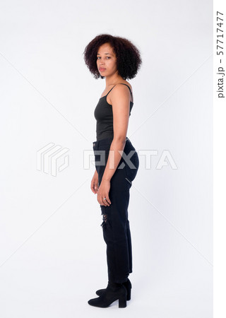 Full body shot profile view of young beautiful African woman looking at camera 57717477