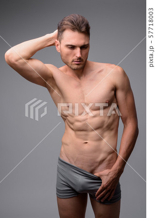 Studio shot of handsome muscular man shirtless 57718003