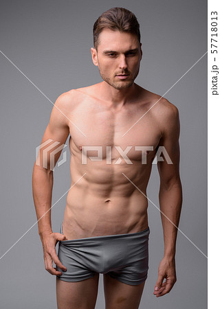 Studio shot of handsome muscular man shirtless 57718013