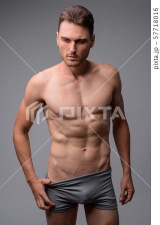 Studio shot of handsome muscular man shirtless 57718016