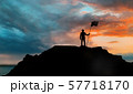 silhouette of businessman with flag on mountain 57718170