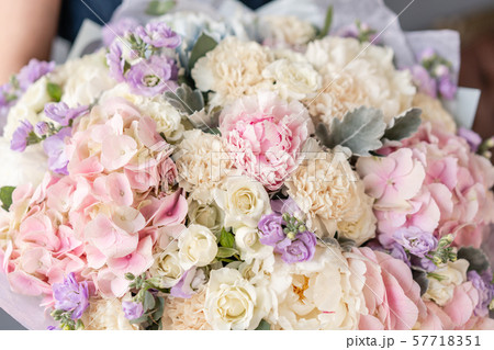 Large Beautiful bouquet of mixed flowers in woman hand. Floral shop concept . Beautiful fresh cut 57718351