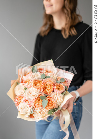 White and peach color. Beautiful bouquet of mixed flowers in womans hands. the work of the florist 57718573