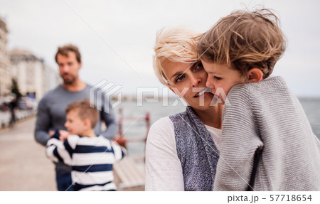 Young family with two small children outdoors on beach. 57718654