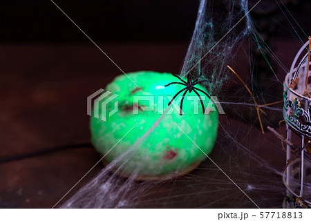 Witch green lamp ball with candles and cobwebs on a black background. Halloween party 57718813