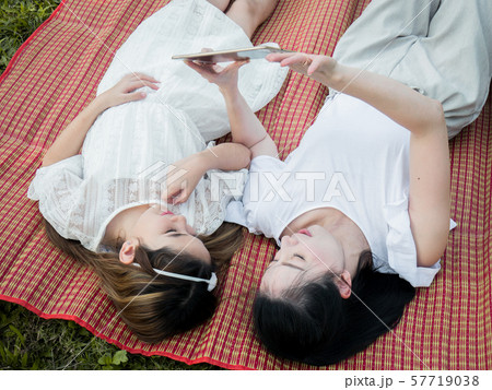 Mother and children are playing the tablet on the Mother and children are playing the tablet on the 57719038
