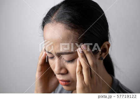 Young woman with of stress and headaches. 57719122