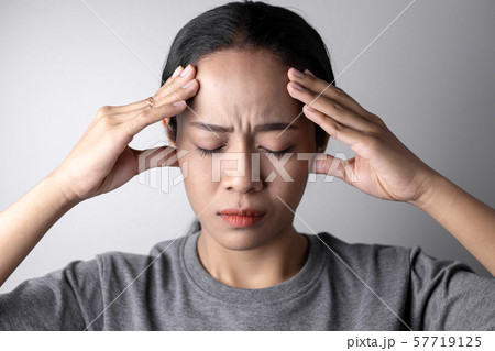 Young woman with of stress and headaches. 57719125