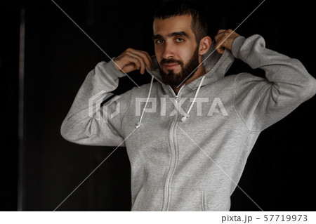 Young stylish man with a beard with a hood Young stylish man with a beard with a hood 57719973