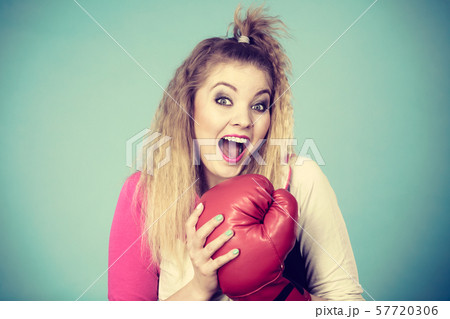Funny girl in red gloves playing sports boxing Funny girl in red gloves playing sports boxing 57720306