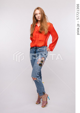Girl in red blouse and jeans posing on isolated Girl in red blouse and jeans posing on isolated 57721366