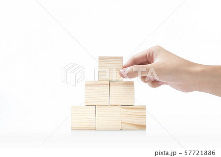 Hand build a pyramid from a wooden block 57721886
