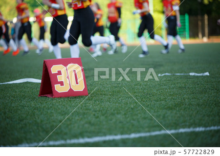 Photo of soccer field with number thirty running football players on blurred background Photo of soccer field with number thirty running football players on blurred background 57722829