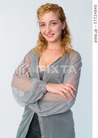 Portrait of happy beautiful blonde woman smiling with arms crossed 57724840