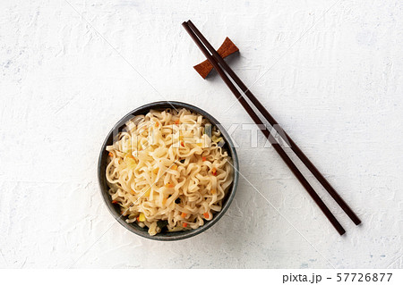 Instant soba noodles with carrot, shot from above on a teal blue background with chopsticks and copy 57726877
