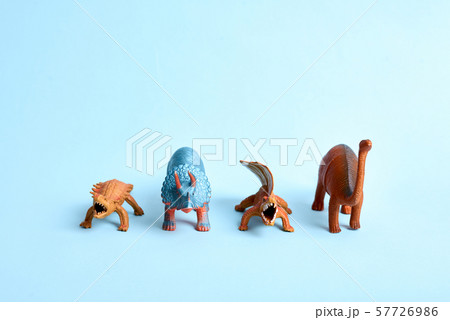 Tower of toy dinosaurus on blue background. Funny prehistoric poster. Copy space 57726986