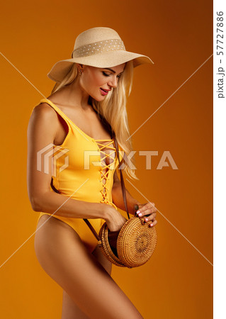 cute blonde girl in orange swimsuit posing 57727886