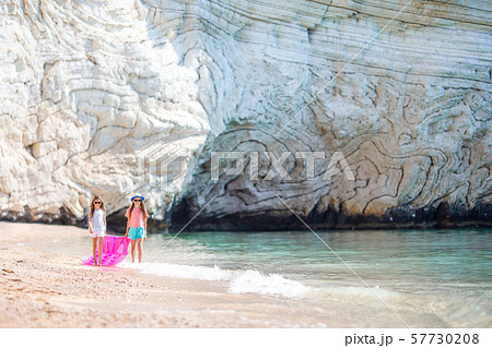 Little girls having fun at tropical beach during summer vacation playing together 57730208