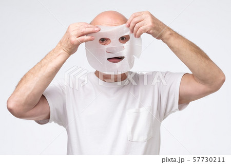 Hispanic mature man in a cosmetic mask skin care 57730211