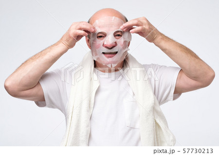 Hispanic mature man in a cosmetic mask skin care Hispanic mature man in a cosmetic mask skin care 57730213