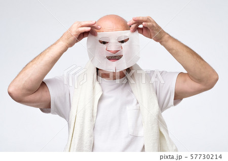 Hispanic mature man in a cosmetic mask skin care Hispanic mature man in a cosmetic mask skin care 57730214