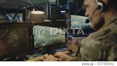 Soldiers controlling rocket launch on computer Soldiers controlling rocket launch on computer 57730552