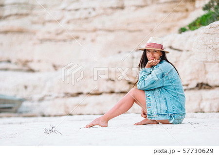 Woman laying on the beach enjoying summer holidays looking at the sea 57730629
