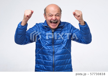 Lucky successful senior man exclaiming, clenching fists, having winning look 57730838
