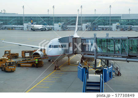 MUNICH, GERMANY - OCTOBER 15, 2016: An airplane at the gate of airport, jetway 57730849