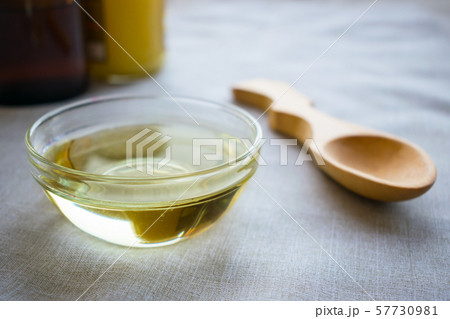 Liquid coconut MCT oil in round glass bowl with 57730981