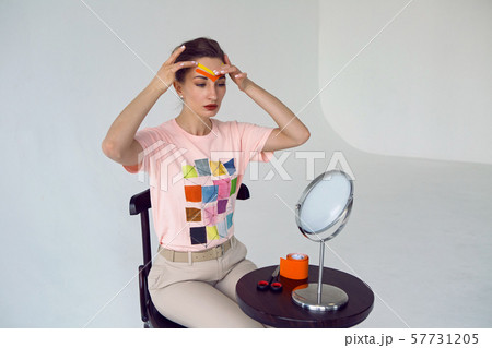 young girl beautician paste on the face of kinesio tape young girl beautician paste on the face of kinesio tape 57731205