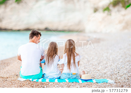 Father and two daughters on the beach 57731279