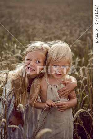 Woman with arms outstretched in a wheat field 57731327