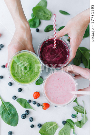 Row of healthy fresh fruit and vegetable smoothies with assorted ingredients 57731595