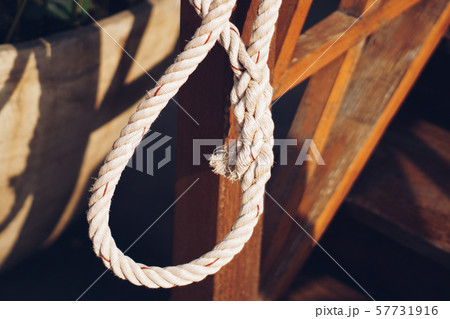 The old white rope was tied in a circle. 57731916