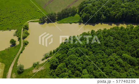 Aerial landscape nature - Dense green forest, green meadows, lake in southern Russia 57740230