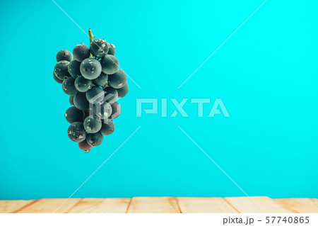 Beautiful wine violet grapes on a red wooden table Beautiful wine violet grapes on a red wooden table 57740865