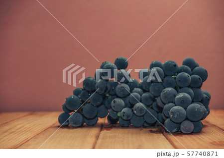 Beautiful wine violet grapes on a red wooden table 57740871