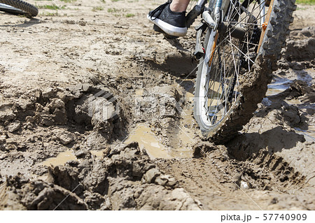 the Bicycle wheel is stuck in the mud. Close up the Bicycle wheel is stuck in the mud. Close up 57740909