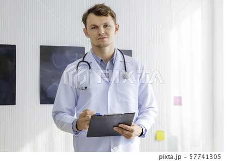 Happy man doctor possing and wearing a stethoscope 57741305