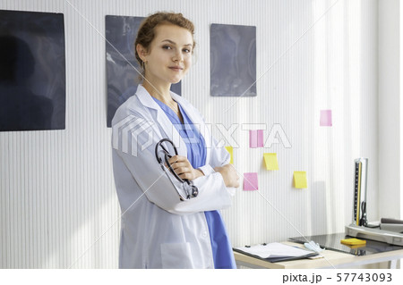 Smiling woman doctor possing and wearing a 57743093