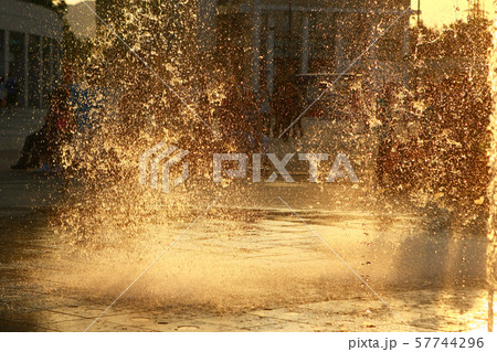 Happy kids have fun playing in city water fountain Happy kids have fun playing in city water fountain 57744296