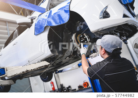 Asian male car technician car maintenance for 57744982